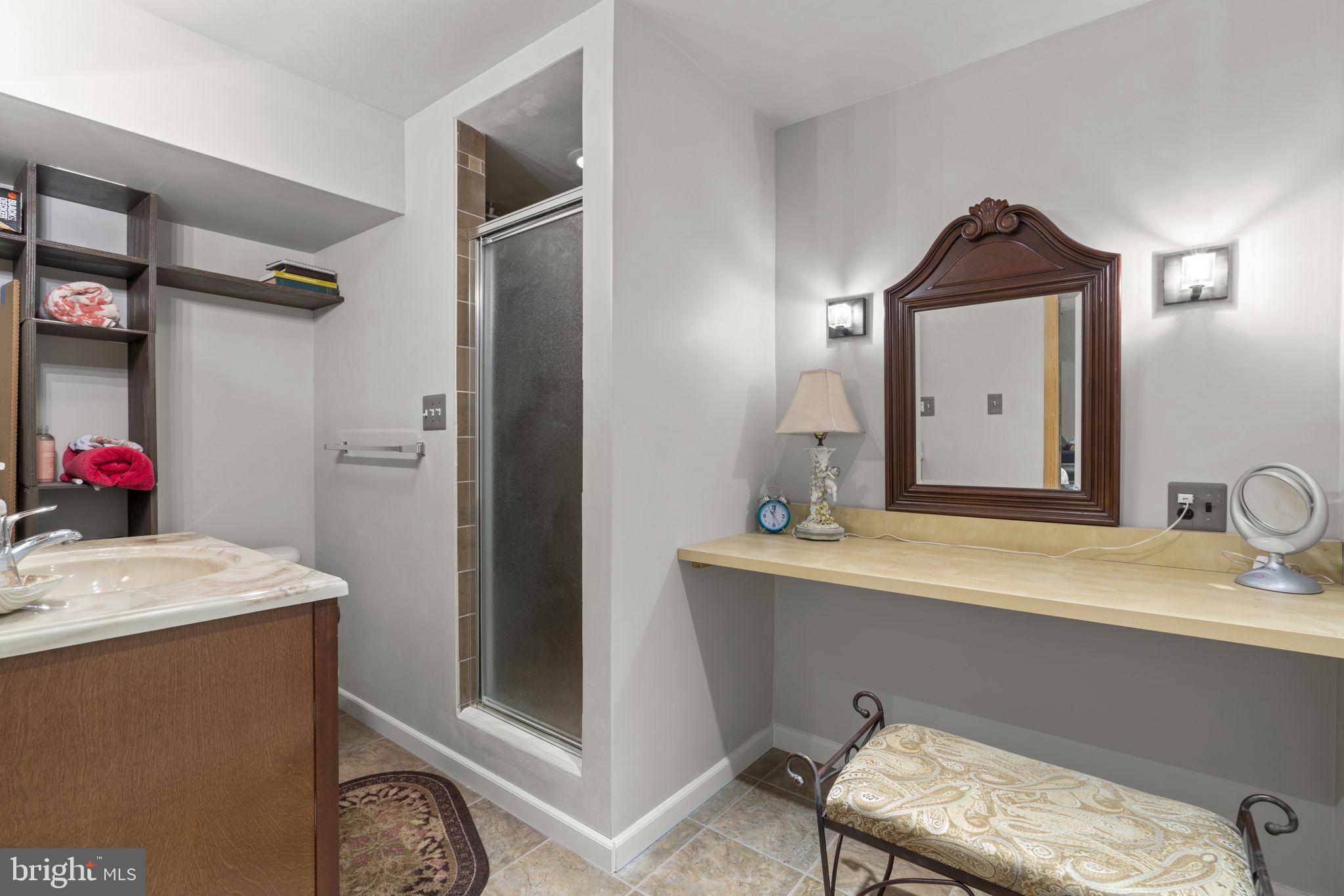 8057 Mayer Avenue Pasadena, MD 21122 - Photo 23 of 26 a bathroom with a sink vanity and a mirror