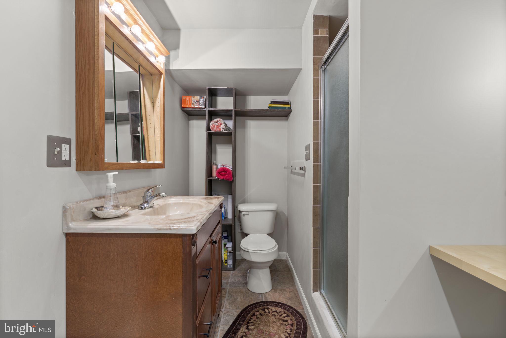 8057 Mayer Avenue Pasadena, MD 21122 - Photo 24 of 26 a bathroom with a sink toilet and shower
