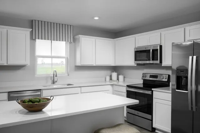 a kitchen with a sink a stove and cabinets