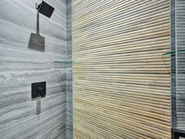 a kitchen with stainless steel appliances granite countertop a sink a stove a refrigerator and island with wooden floor