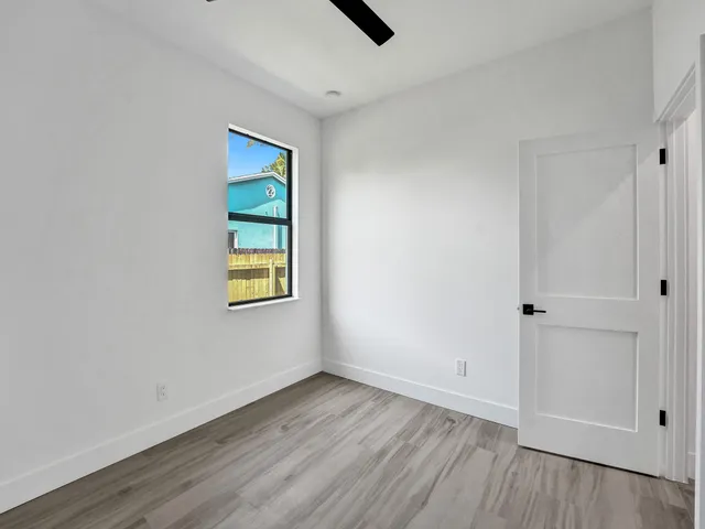 a kitchen with stainless steel appliances granite countertop a refrigerator a stove and a wooden floors