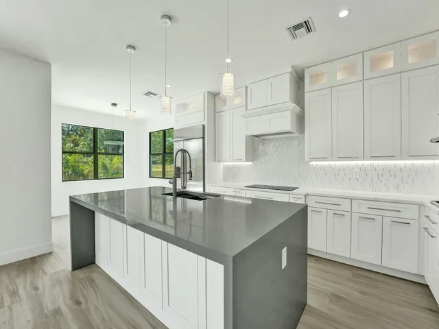 a view of a kitchen with wooden floor and a sink