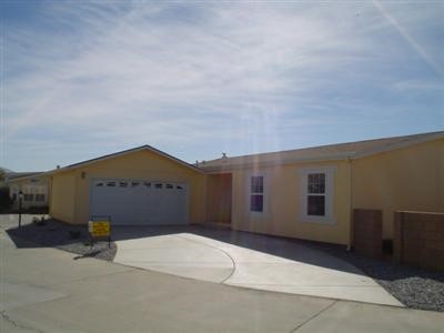 22241 Nisqually Road, Unit 83 Apple Valley, CA 92308 - Photo 1 of 1 a front view of a house with a yard