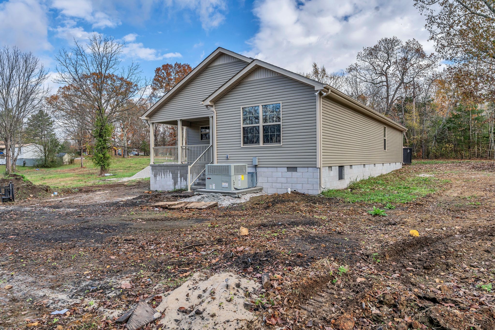 329 Summitville Road Manchester, TN 37355 - Photo 31 of 34 a view of a small white house next to a yard with big trees