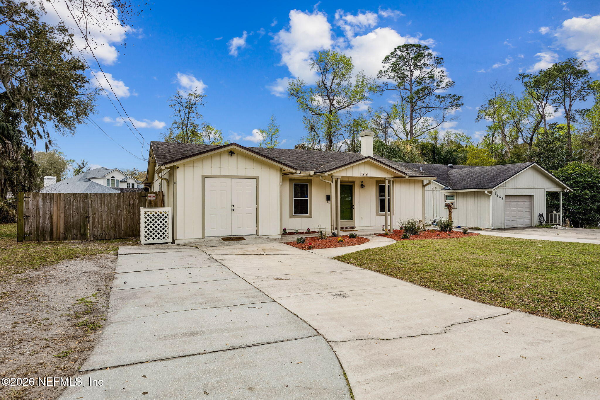 1888 Clemson Road Jacksonville, FL 32217 - Photo 37 of 41 a front view of a house with a garden and trees