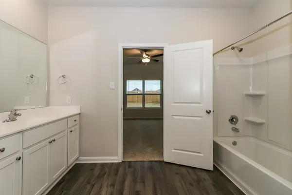 a bathroom with a bathtub and a sink