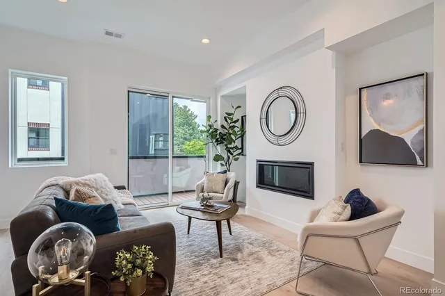 a living room with furniture a window and a fireplace