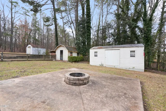 a kitchen with white cabinets and wooden floor