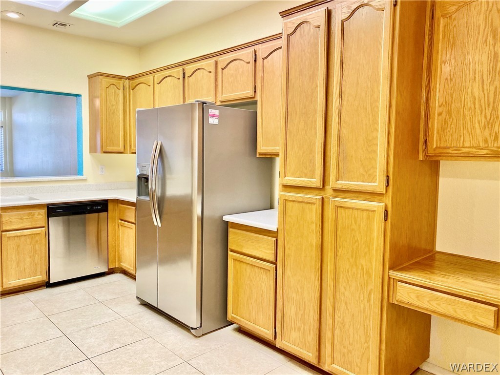 3171 Partridge Run Street Laughlin, NV 89029 - Photo 11 of 36 a bathroom with a refrigerator a stove and cabinets