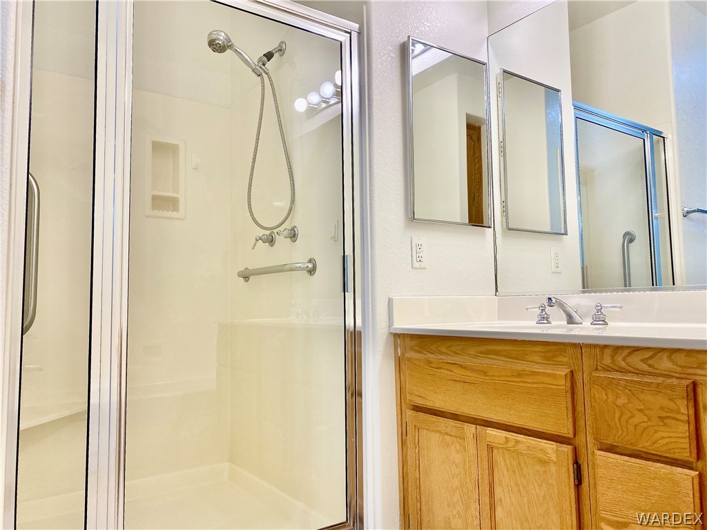 3171 Partridge Run Street Laughlin, NV 89029 - Photo 20 of 36 a bathroom with a granite countertop mirror sink and vanity