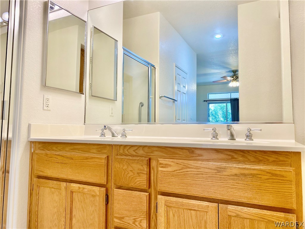 3171 Partridge Run Street Laughlin, NV 89029 - Photo 21 of 36 a bathroom with a granite countertop sink and a large mirror