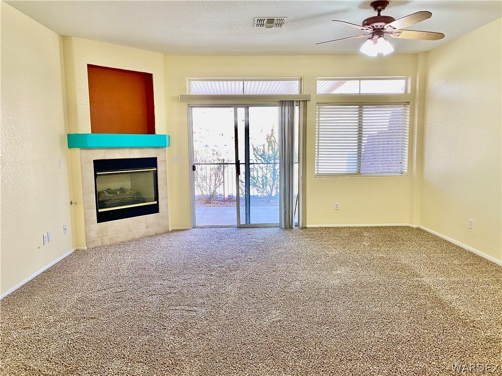 3171 Partridge Run Street Laughlin, NV 89029 - Photo 4 of 36 a view of an empty room with a fireplace and a window