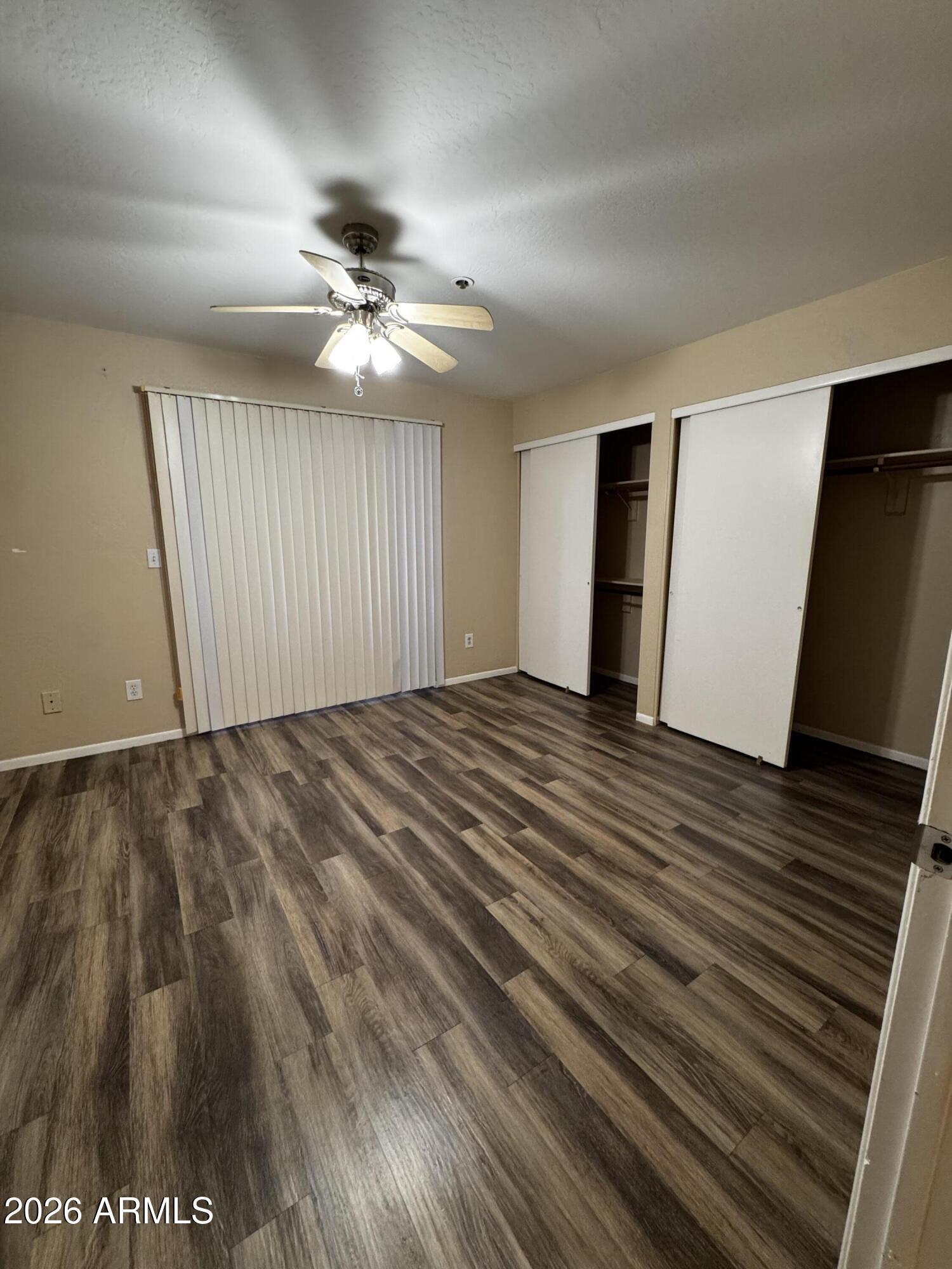 12123 West Bell Road, Unit 258 Surprise, AZ 85378 - Photo 13 of 30 wooden floor in an empty room with a window