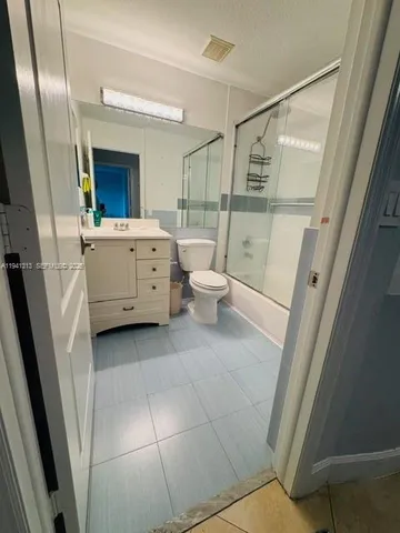 a bedroom with a bed and a mirror