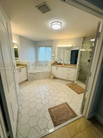 a kitchen with a cabinets and white appliances