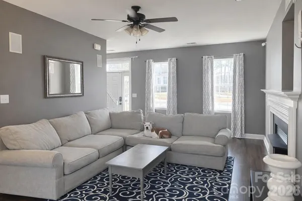 a living room with furniture a fireplace and a window