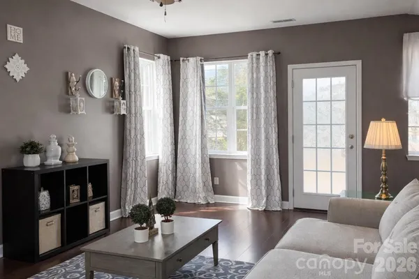 a living room with furniture and large windows