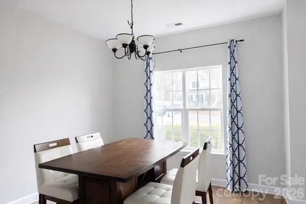 a view of a dining room with a table and chairs