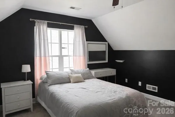 a bedroom with a bed and a black space