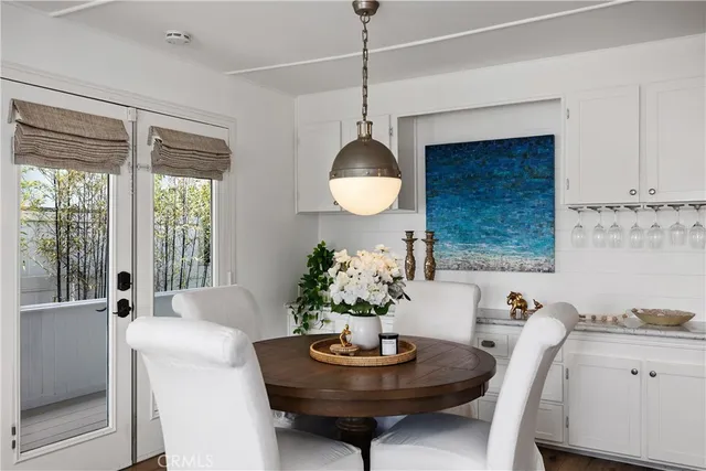 a large kitchen with a table chairs refrigerator and microwave