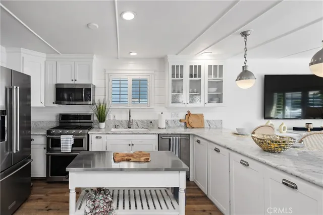 a kitchen with a sink appliances and cabinets