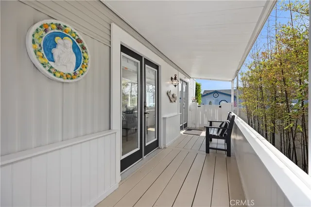 a living room with furniture a flat screen tv and kitchen view