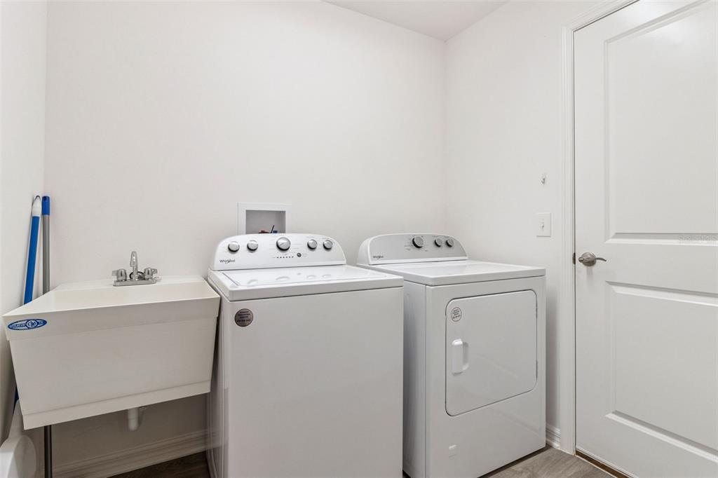 6338 Flaxmayer Road The Villages, FL 32163 - Photo 16 of 19 a utility room with dryer and washer