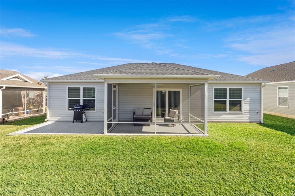 6338 Flaxmayer Road The Villages, FL 32163 - Photo 17 of 19 a front view of house with a garden and patio