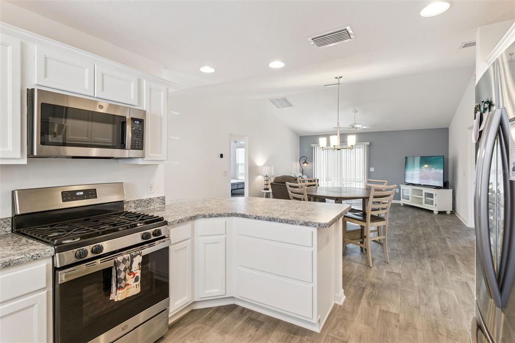 6338 Flaxmayer Road The Villages, FL 32163 - Photo 3 of 19 a kitchen with a stove and a microwave