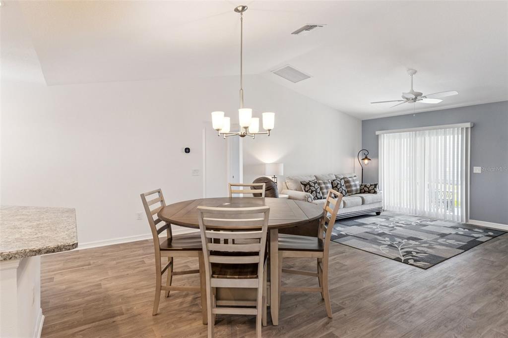 6338 Flaxmayer Road The Villages, FL 32163 - Photo 5 of 19 a view of a dining room with furniture and chandelier