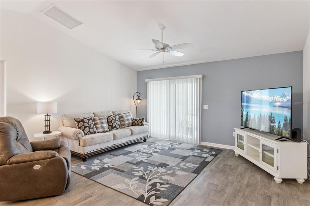 6338 Flaxmayer Road The Villages, FL 32163 - Photo 8 of 19 a living room with furniture and a flat screen tv