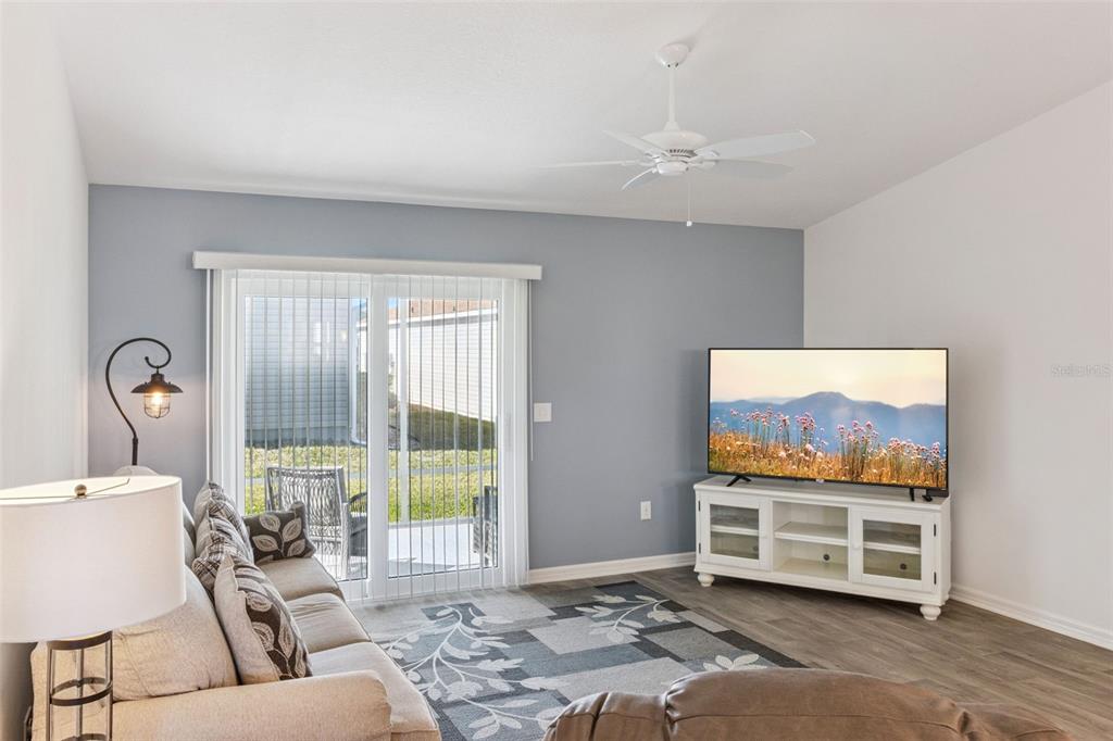 6338 Flaxmayer Road The Villages, FL 32163 - Photo 9 of 19 a living room with furniture a window and a flat screen tv