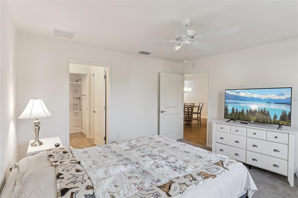 6338 Flaxmayer Road The Villages, FL 32163 - Photo 10 of 19 a bedroom with a bed and a flat screen tv in it