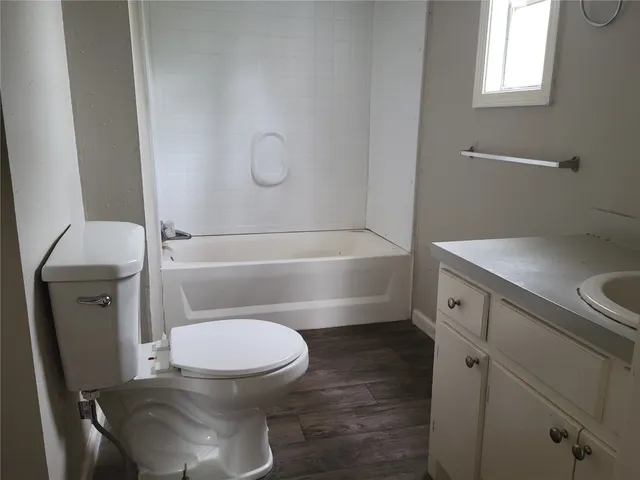 a bathroom with a toilet a sink and bathtub