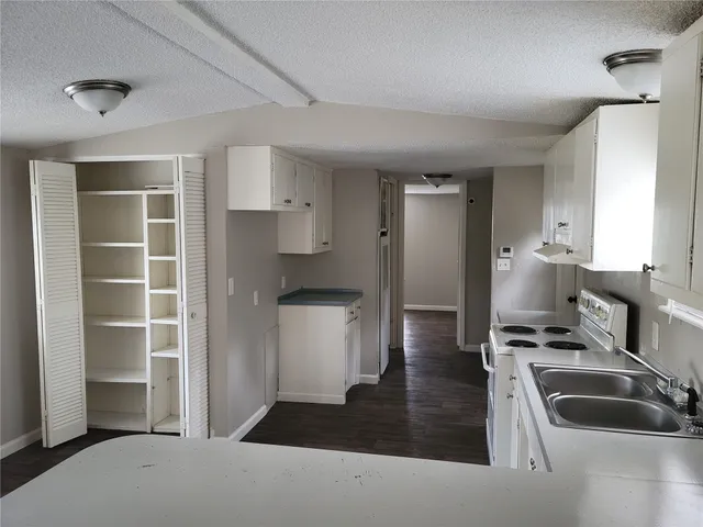a kitchen with refrigerator and window