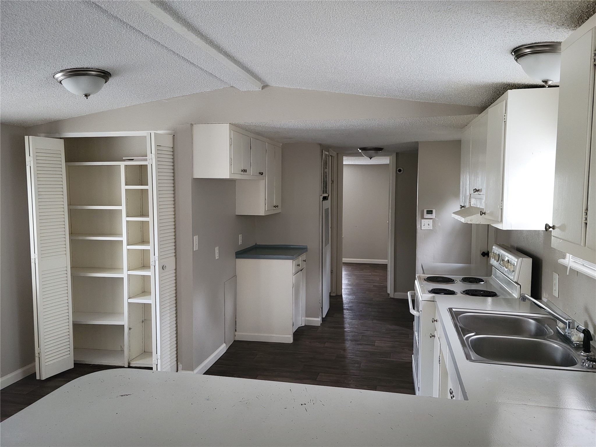 13205 13th Street Splendora, TX 77372 - Photo 2 of 16 a kitchen with refrigerator and window