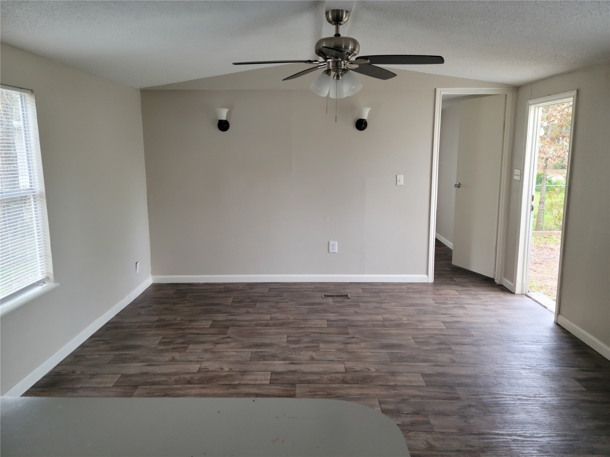13205 13th Street Splendora, TX 77372 - Photo 5 of 16 a view of an empty room with window and wooden floor