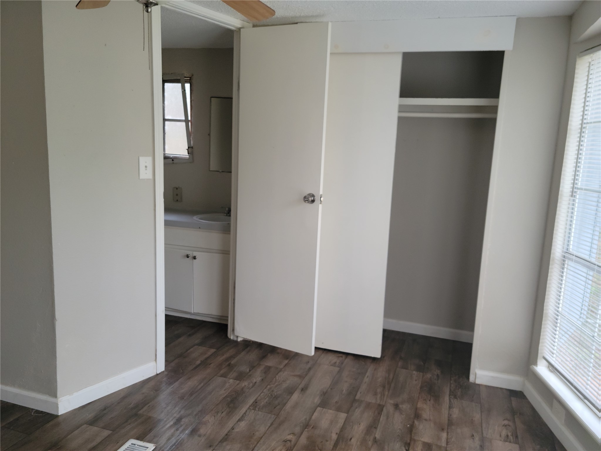 13205 13th Street Splendora, TX 77372 - Photo 9 of 16 a view of hallway with bathroom and wooden floor
