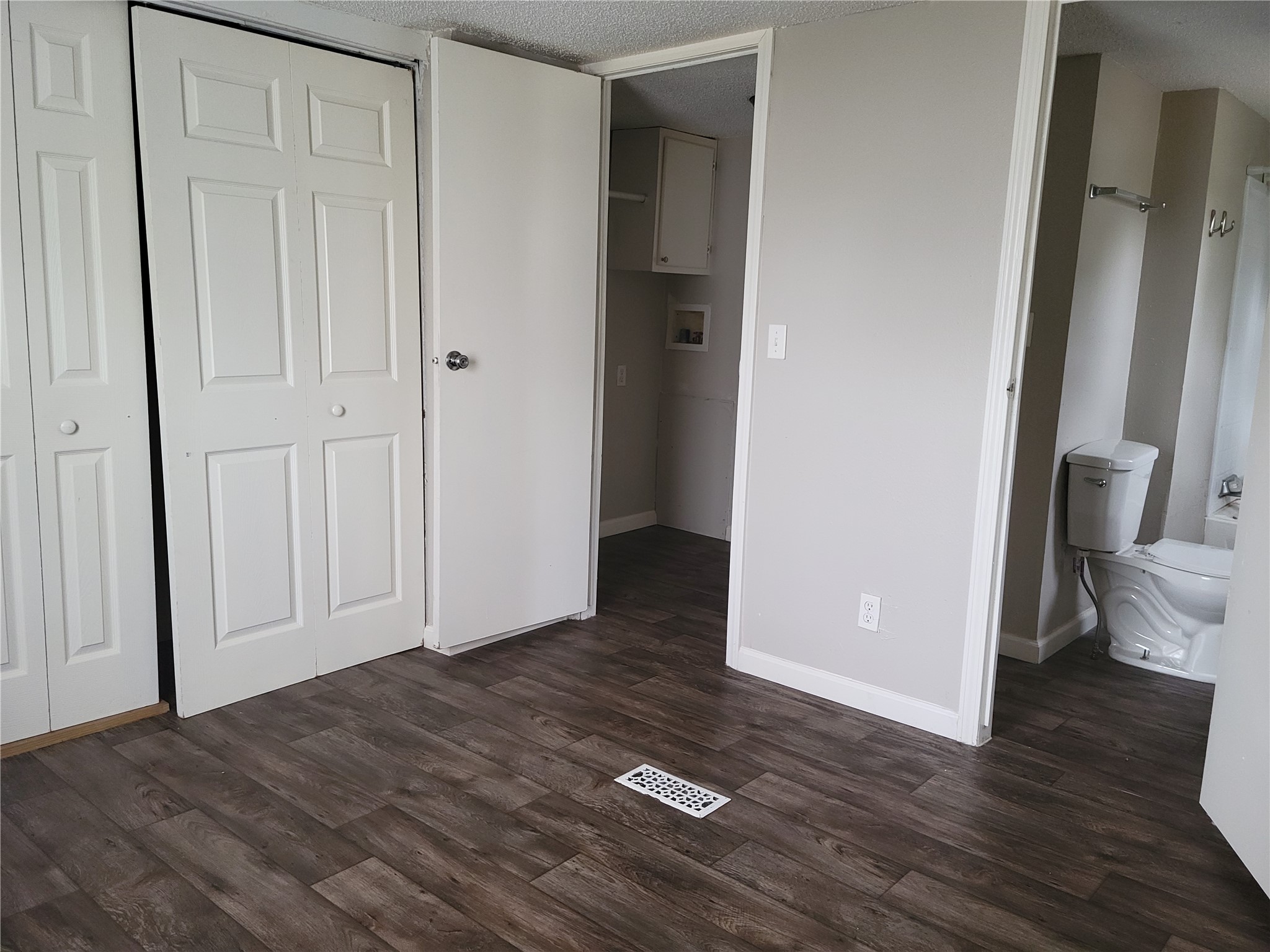 13205 13th Street Splendora, TX 77372 - Photo 10 of 16 an empty room with wooden floor and bathroom