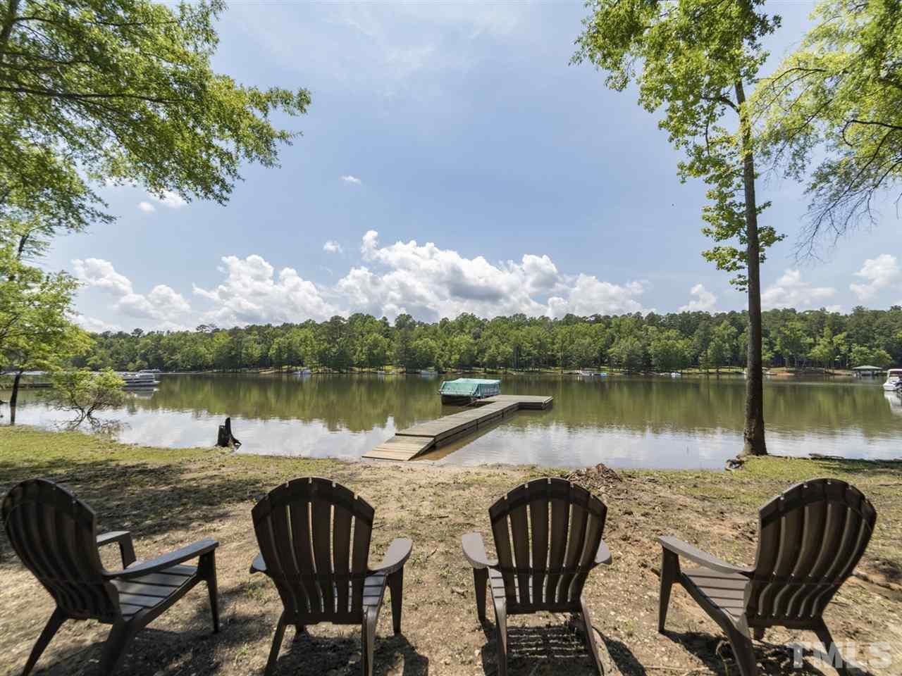 3425 Thomas Road Henderson, NC 27537 - Photo 1 of 25 a view of a lake with table and chairs
