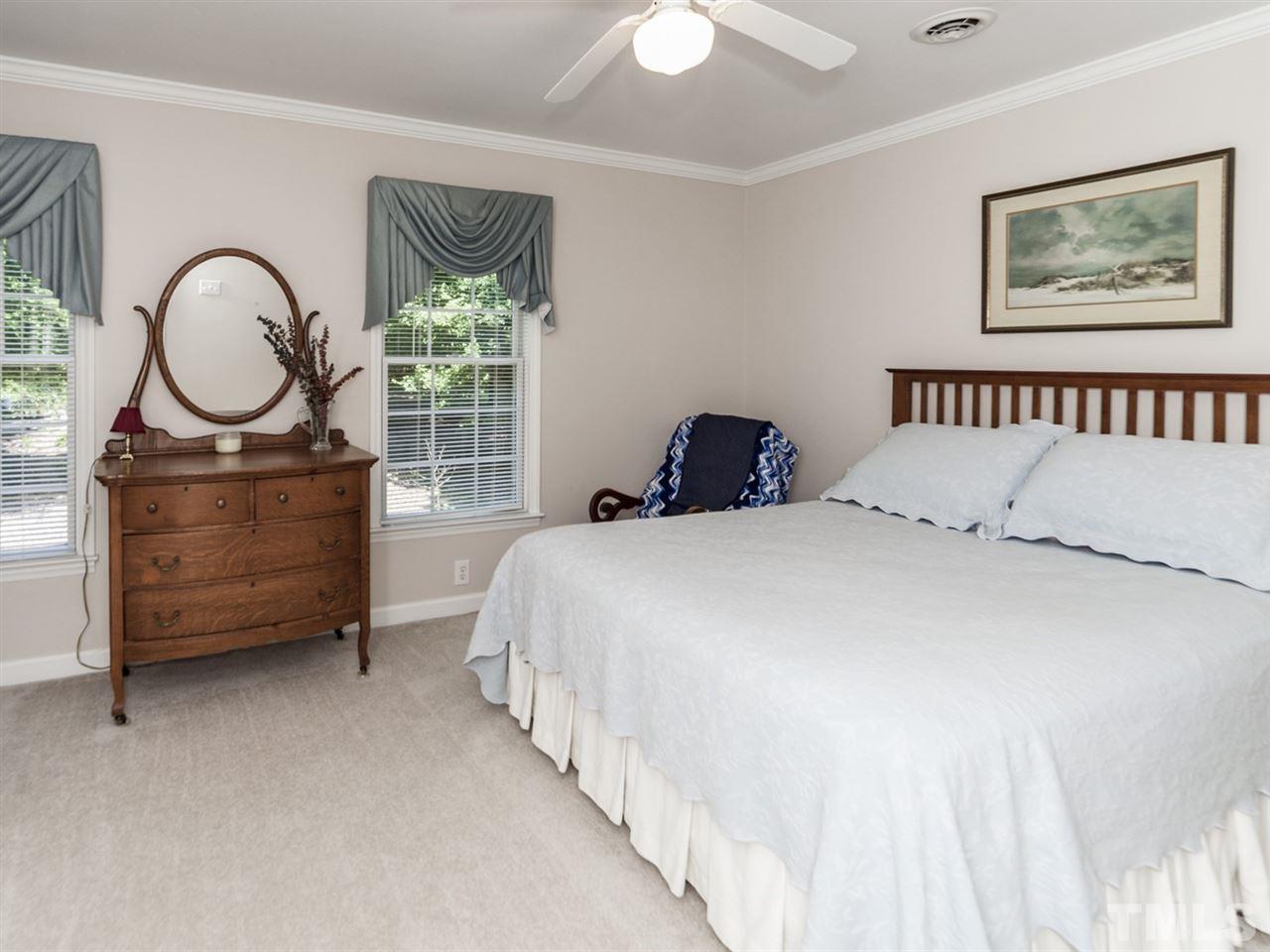 3425 Thomas Road Henderson, NC 27537 - Photo 12 of 25 a bedroom with a bed mirror on desk and a window