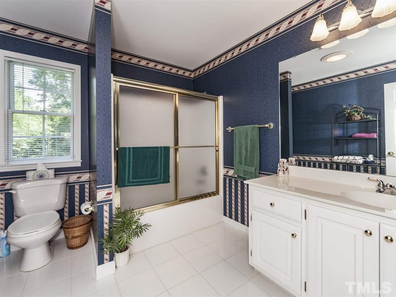 3425 Thomas Road Henderson, NC 27537 - Photo 13 of 25 a bathroom with a double vanity sink toilet and shower