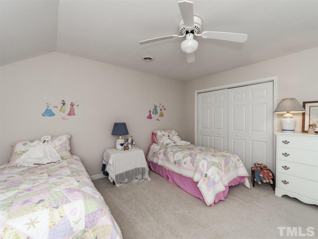 3425 Thomas Road Henderson, NC 27537 - Photo 14 of 25 a bedroom with a bed and a chandelier
