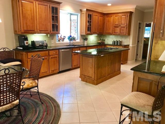 3425 Thomas Road Henderson, NC 27537 - Photo 5 of 25 a kitchen with stainless steel appliances granite countertop a sink a stove top oven a dining table and chairs