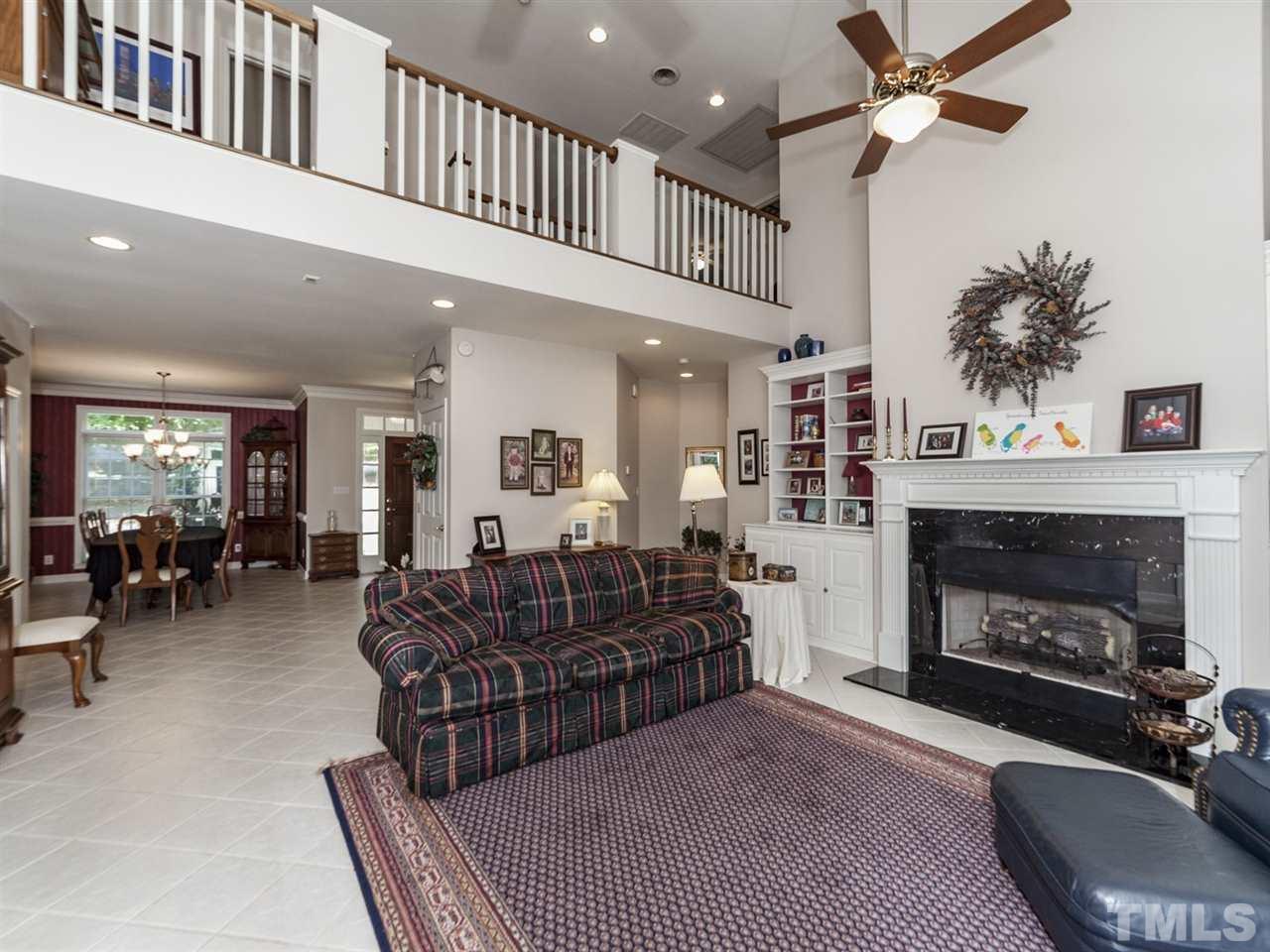 3425 Thomas Road Henderson, NC 27537 - Photo 8 of 25 a living room with furniture a fireplace a rug and a ceiling fan