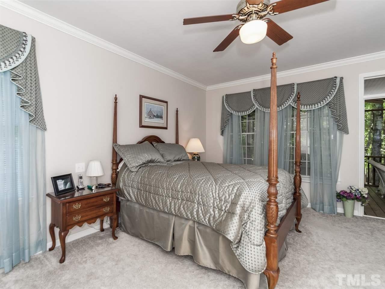 3425 Thomas Road Henderson, NC 27537 - Photo 10 of 25 a bedroom with a bed and a chandelier