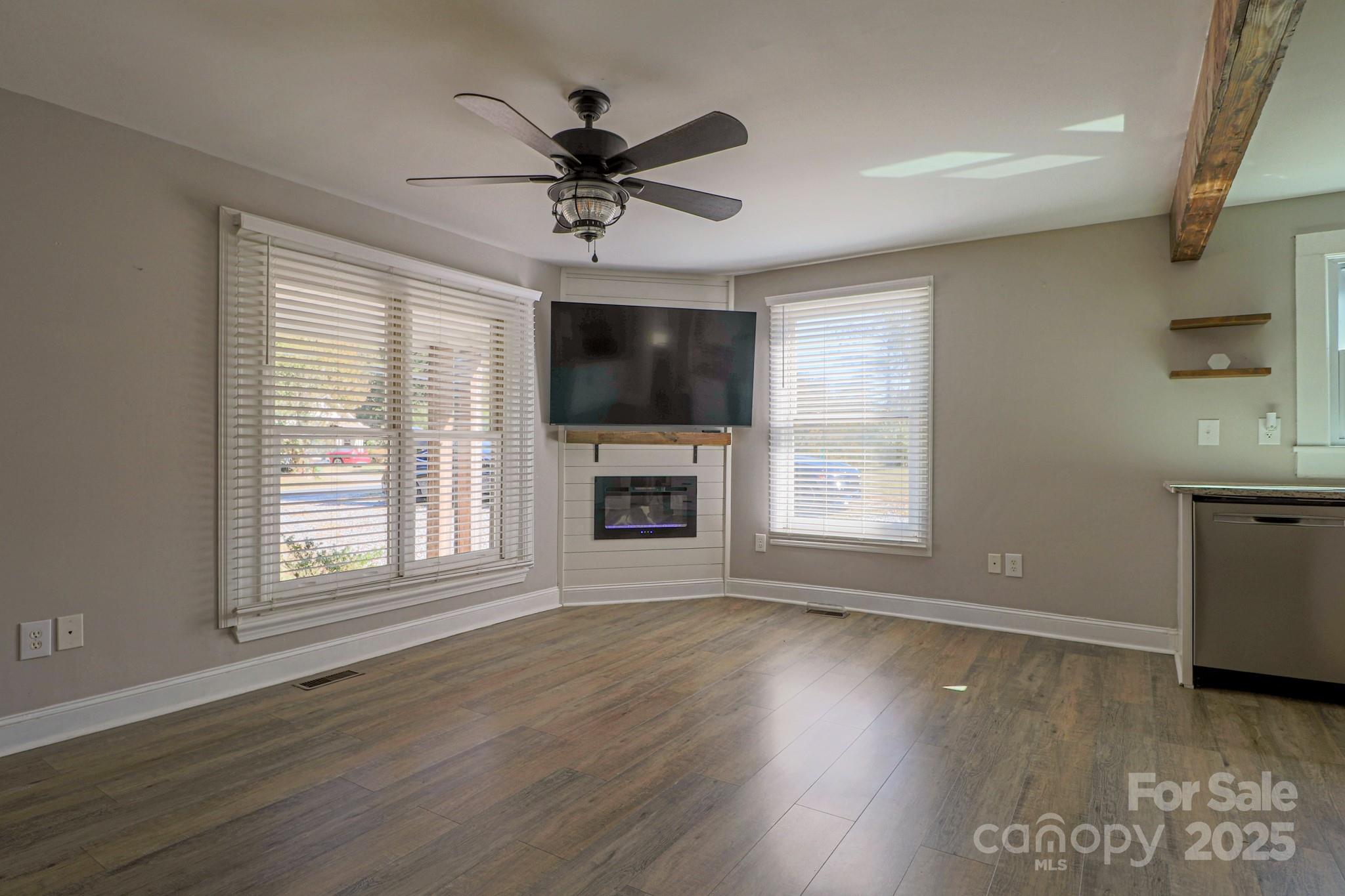 455 Stone Road Salisbury, NC 28146 - Photo 5 of 30 a view of a livingroom with a ceiling fan window and wooden floor