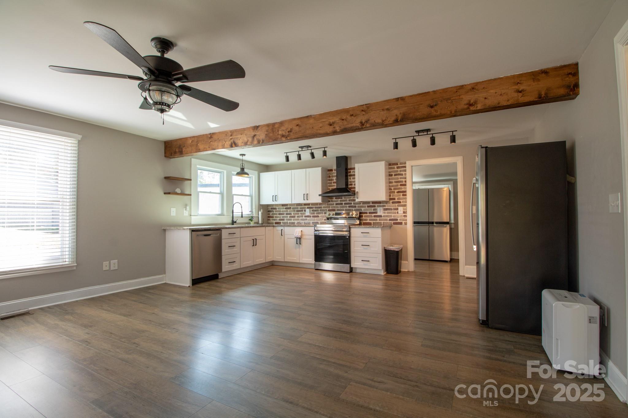 455 Stone Road Salisbury, NC 28146 - Photo 6 of 30 a view of a kitchen with kitchen island stainless steel appliances a refrigerator cabinets and a fireplace