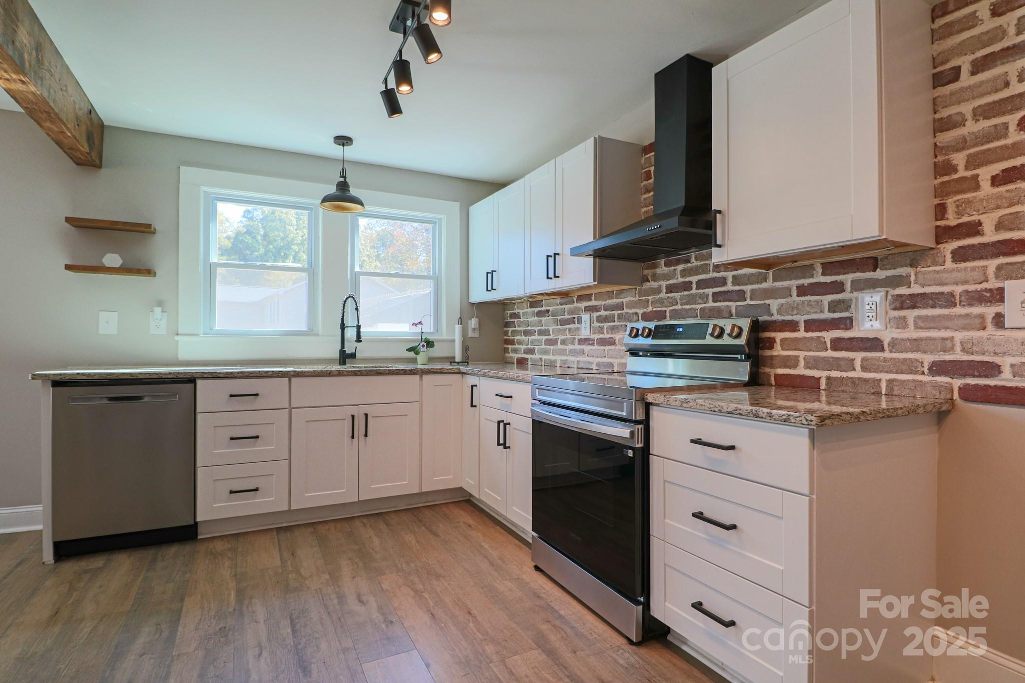 455 Stone Road Salisbury, NC 28146 - Photo 7 of 30 a kitchen with cabinets wooden floor and a sink