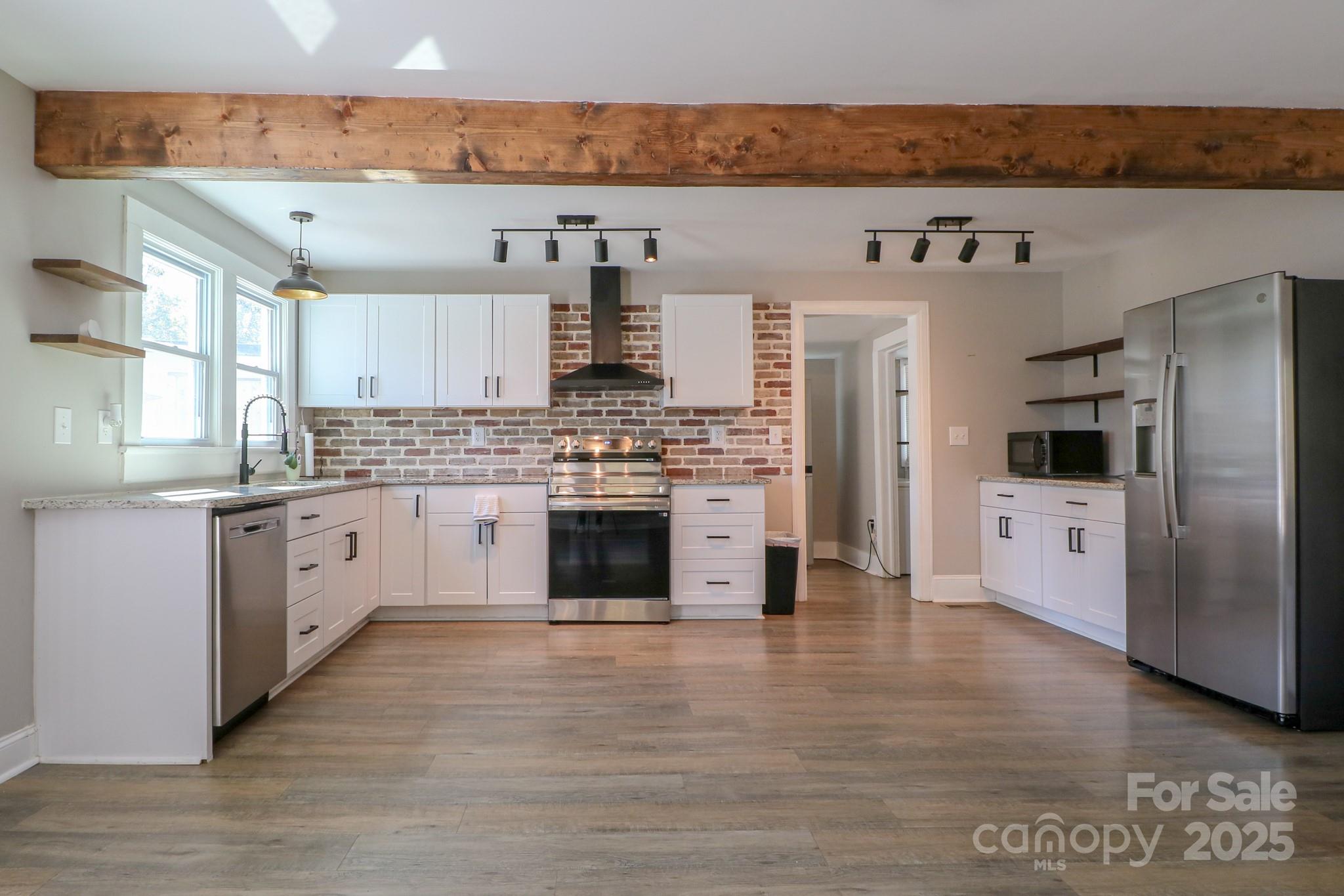 455 Stone Road Salisbury, NC 28146 - Photo 8 of 30 a large kitchen with stainless steel appliances granite countertop a stove a sink and a refrigerator
